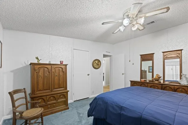 a bedroom with a bed and dresser