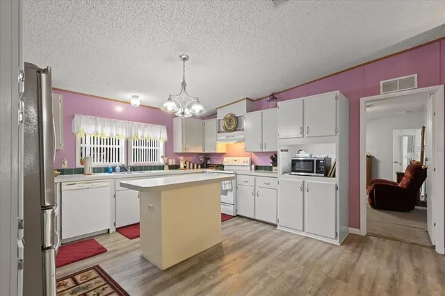 a kitchen with cabinets a sink and appliances