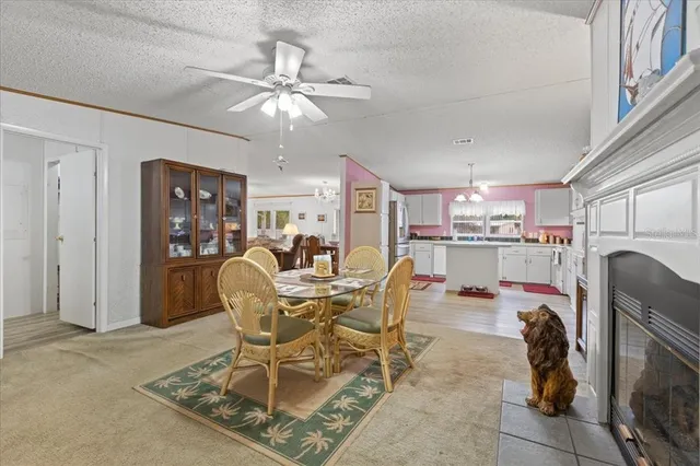 a dining room with furniture a rug and chandelier