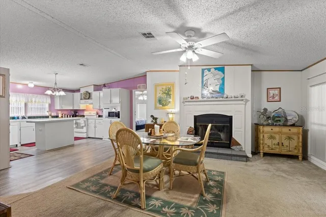 a dining room with furniture a fireplace and chandelier