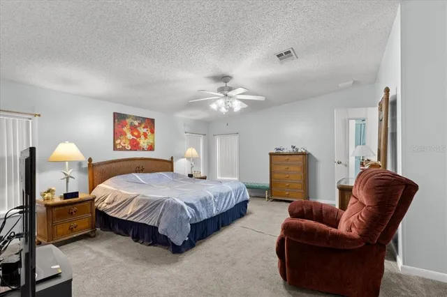 a spacious bedroom with a bed and window