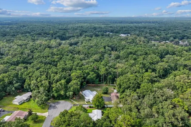 an aerial view of a house with a yard