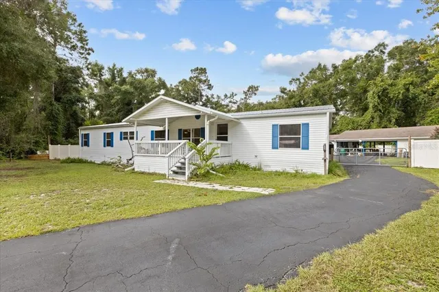 a front view of a house with swimming pool and porch
