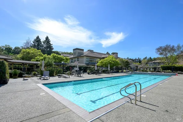 a swimming pool with outdoor seating and yard