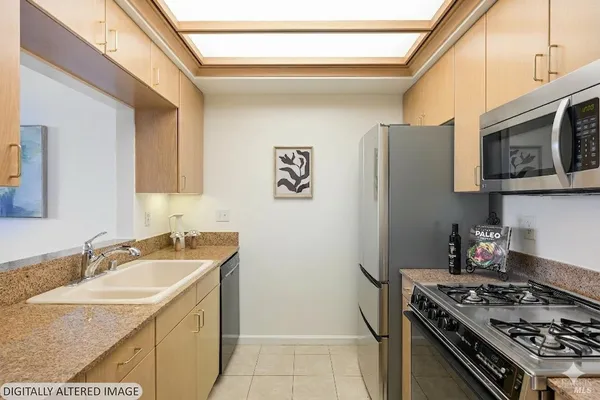 a kitchen with stainless steel appliances granite countertop a sink stove and refrigerator