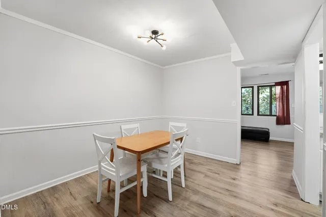 a view of a room with furniture and wooden floor