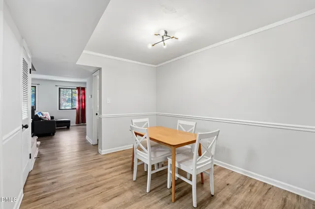 a view of a room with furniture and wooden floor