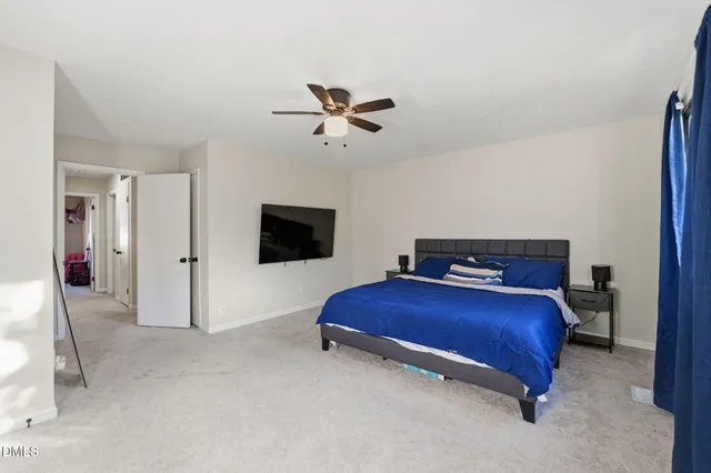 a bedroom with a bed and a tv