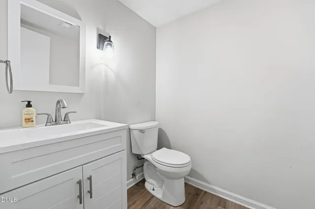 a bathroom with a sink a toilet and mirror