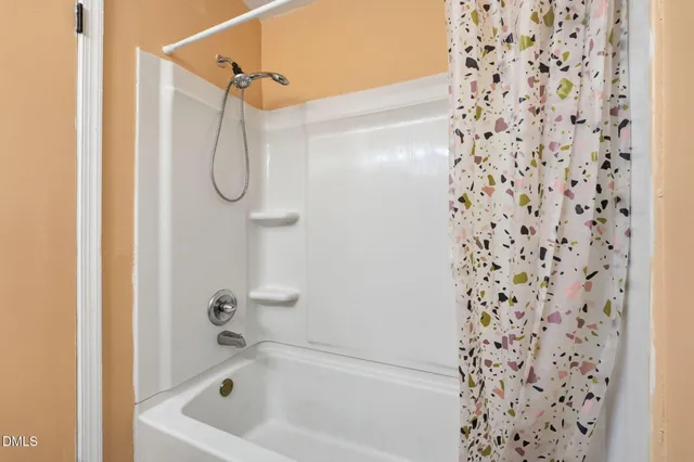 a bathroom with a bath tub and shower