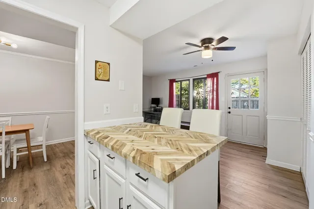 a view of kitchen island with cabinets and wooden floor