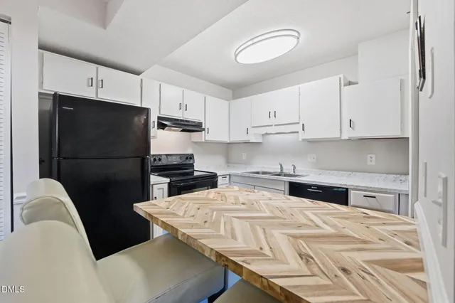 a kitchen with stainless steel appliances granite countertop a refrigerator sink and cabinets