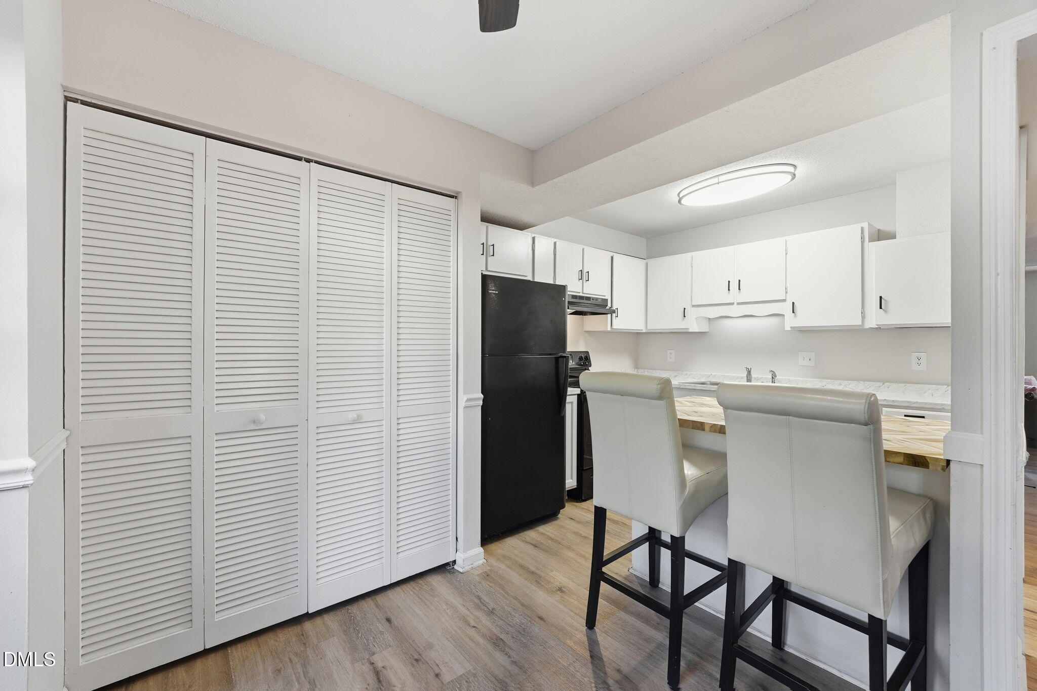 617 Springview Trail Garner, NC 27529 - Photo 7 of 25 a kitchen with a refrigerator and white cabinets