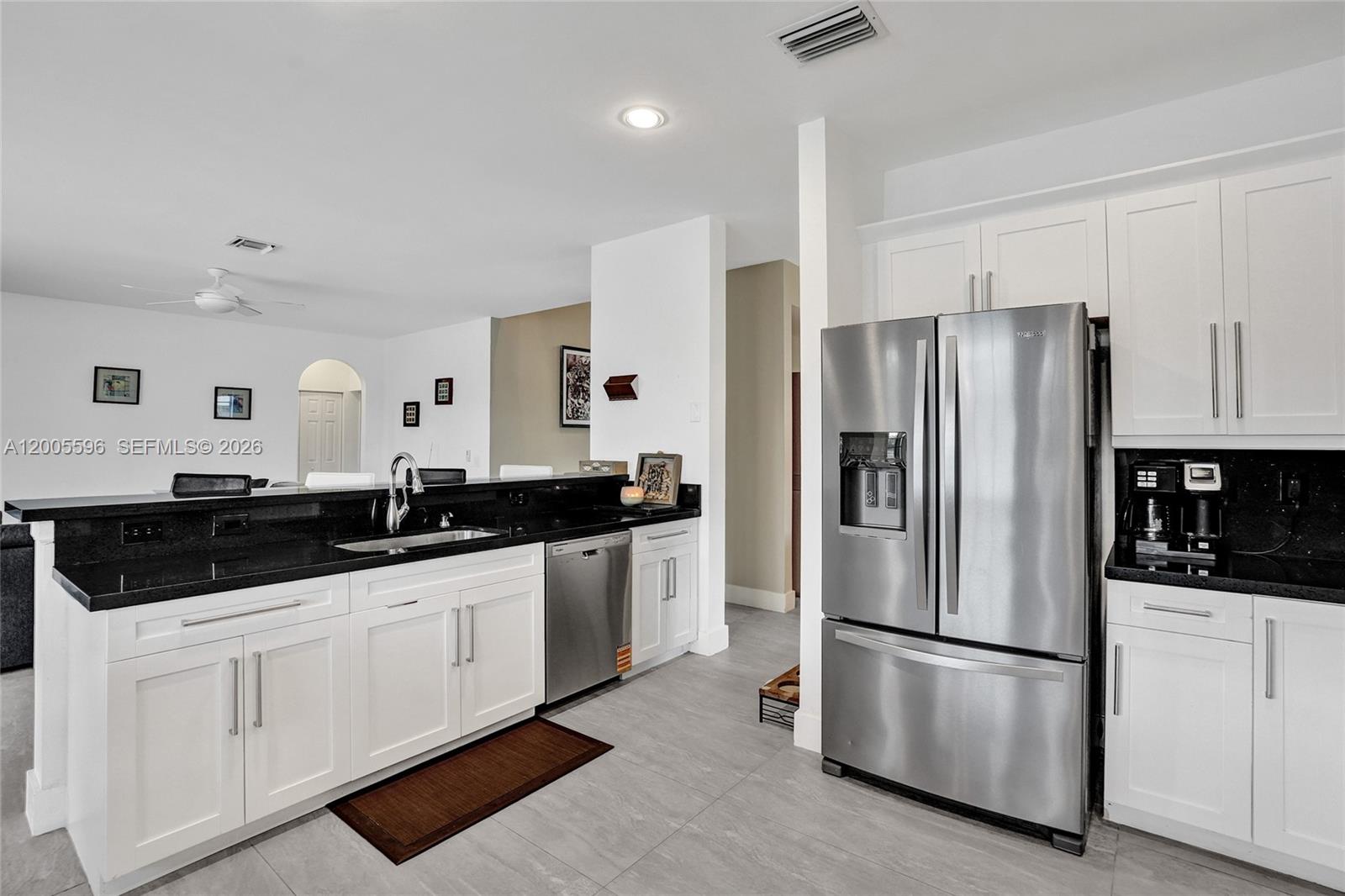 4281 Laurel Ridge Circle Weston, FL 33331 - Photo 31 of 80 a kitchen with stainless steel appliances a refrigerator sink and cabinets