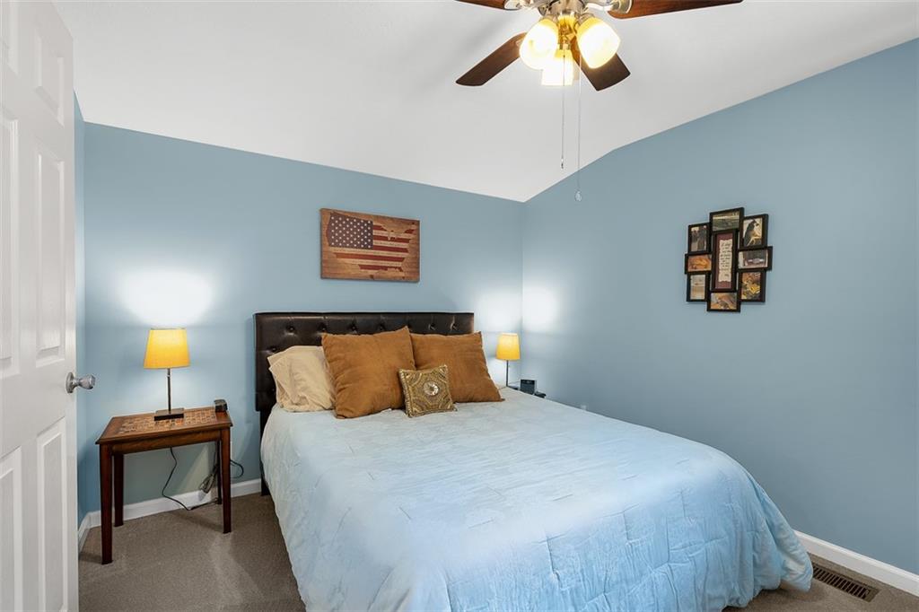 505 Center Grange Road Monaca, PA 15061 - Photo 23 of 43 a bedroom with a bed and a chandelier