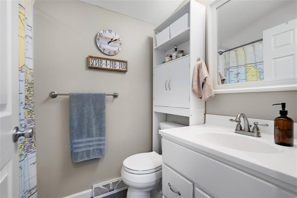 505 Center Grange Road Monaca, PA 15061 - Photo 27 of 43 a bathroom with a sink a toilet and a shower curtain