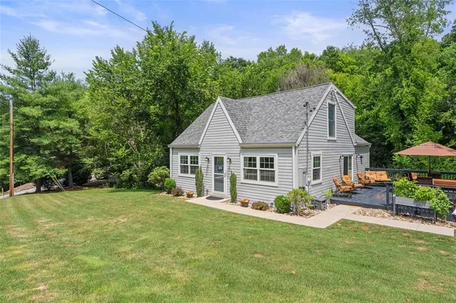 a view of a house with a backyard and a patio