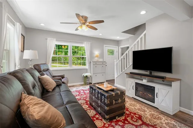 a living room with furniture and a flat screen tv