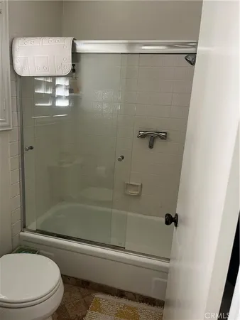 a bathroom with a shower and a toilet