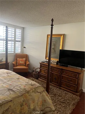 a bedroom with a bed and flat screen tv