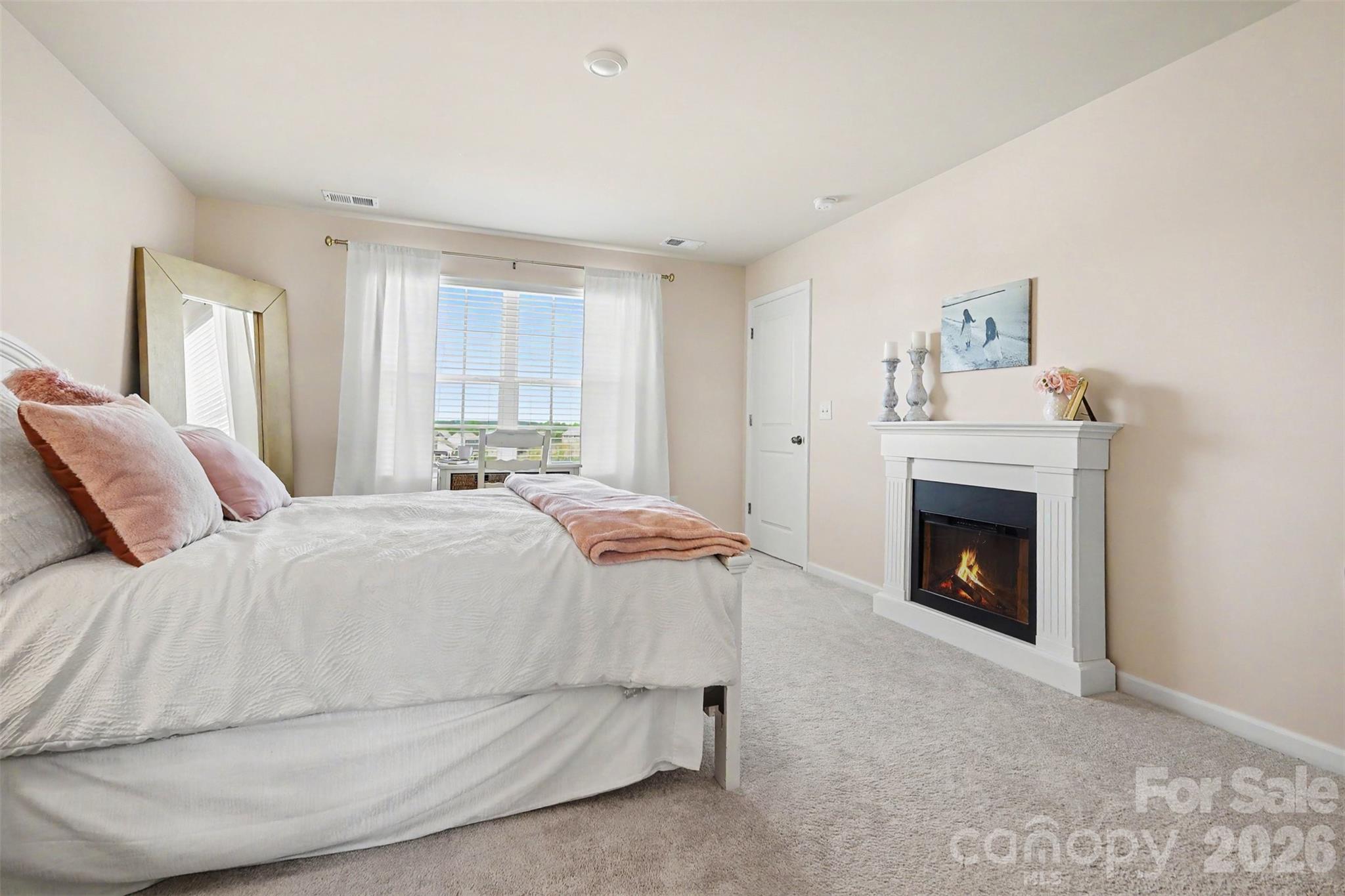 633 Mile Crk Road Edgemoor, SC 29712 - Photo 17 of 26 a spacious bedroom with a bed and a fireplace