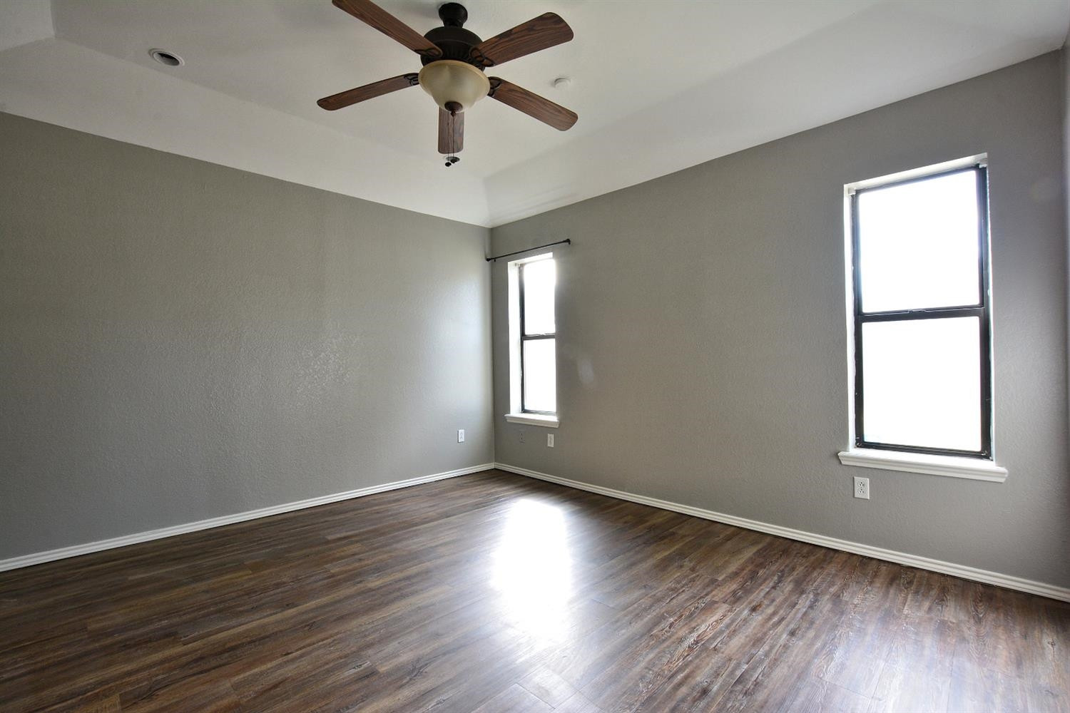 5917 71st Street Lubbock, TX 79424 - Photo 13 of 18 an empty room with wooden floor and windows