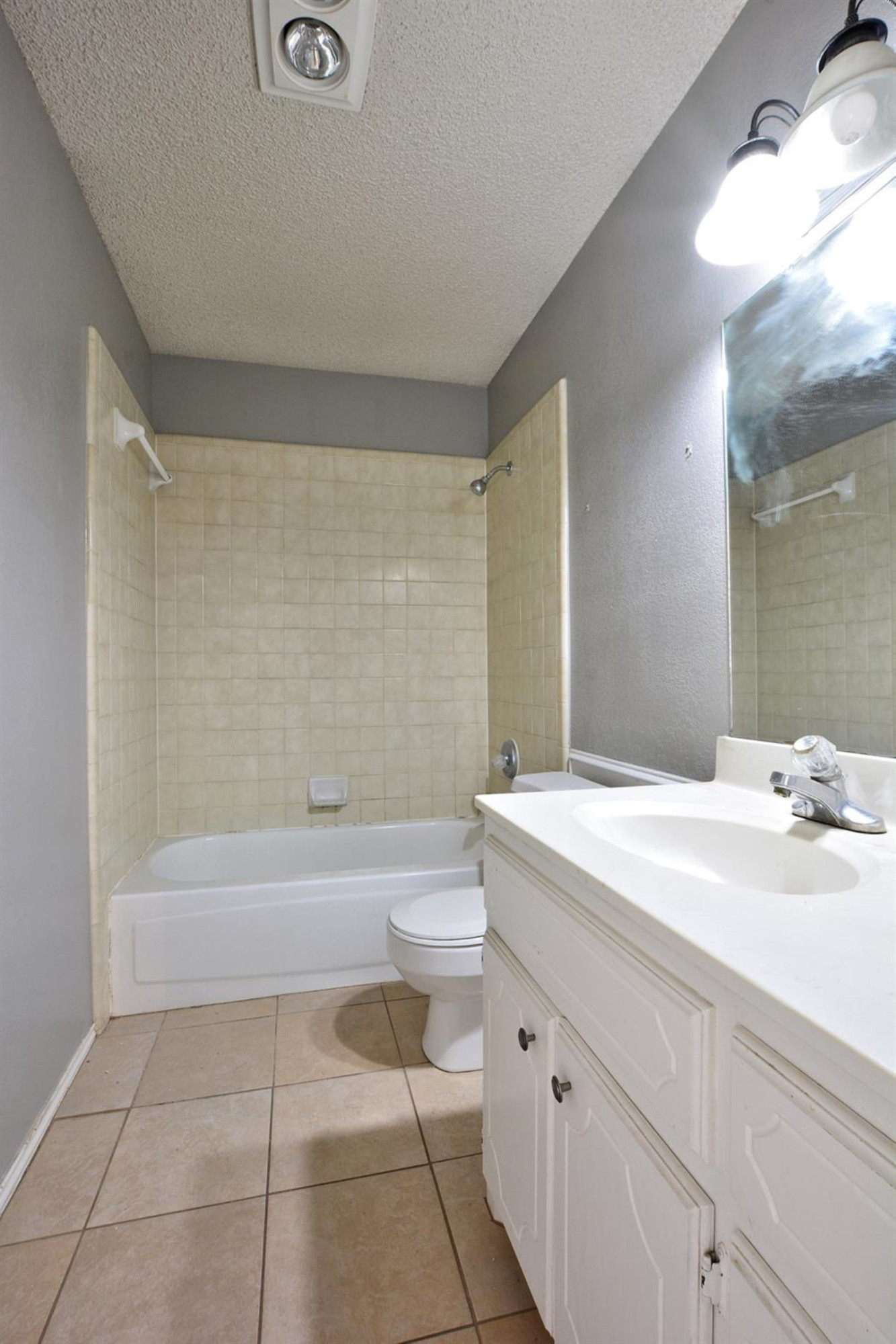 5917 71st Street Lubbock, TX 79424 - Photo 18 of 18 a bathroom with a bathtub sink vanity and a mirror