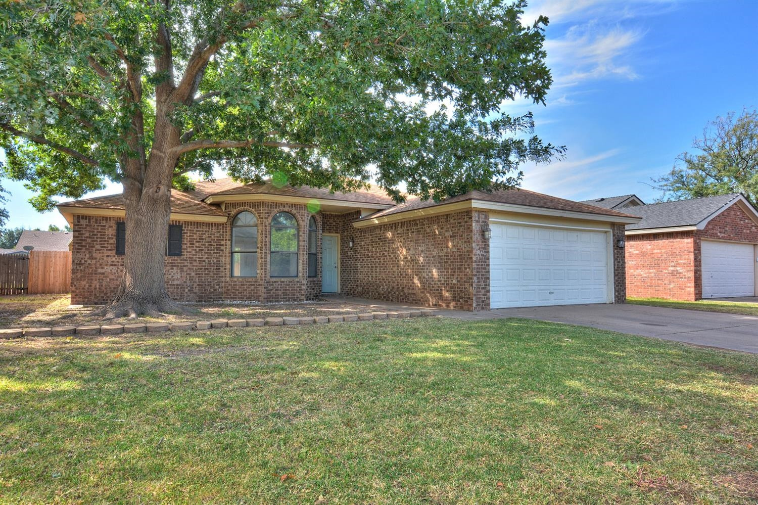 5917 71st Street Lubbock, TX 79424 - Photo 2 of 18 a front view of a house with a yard and garage