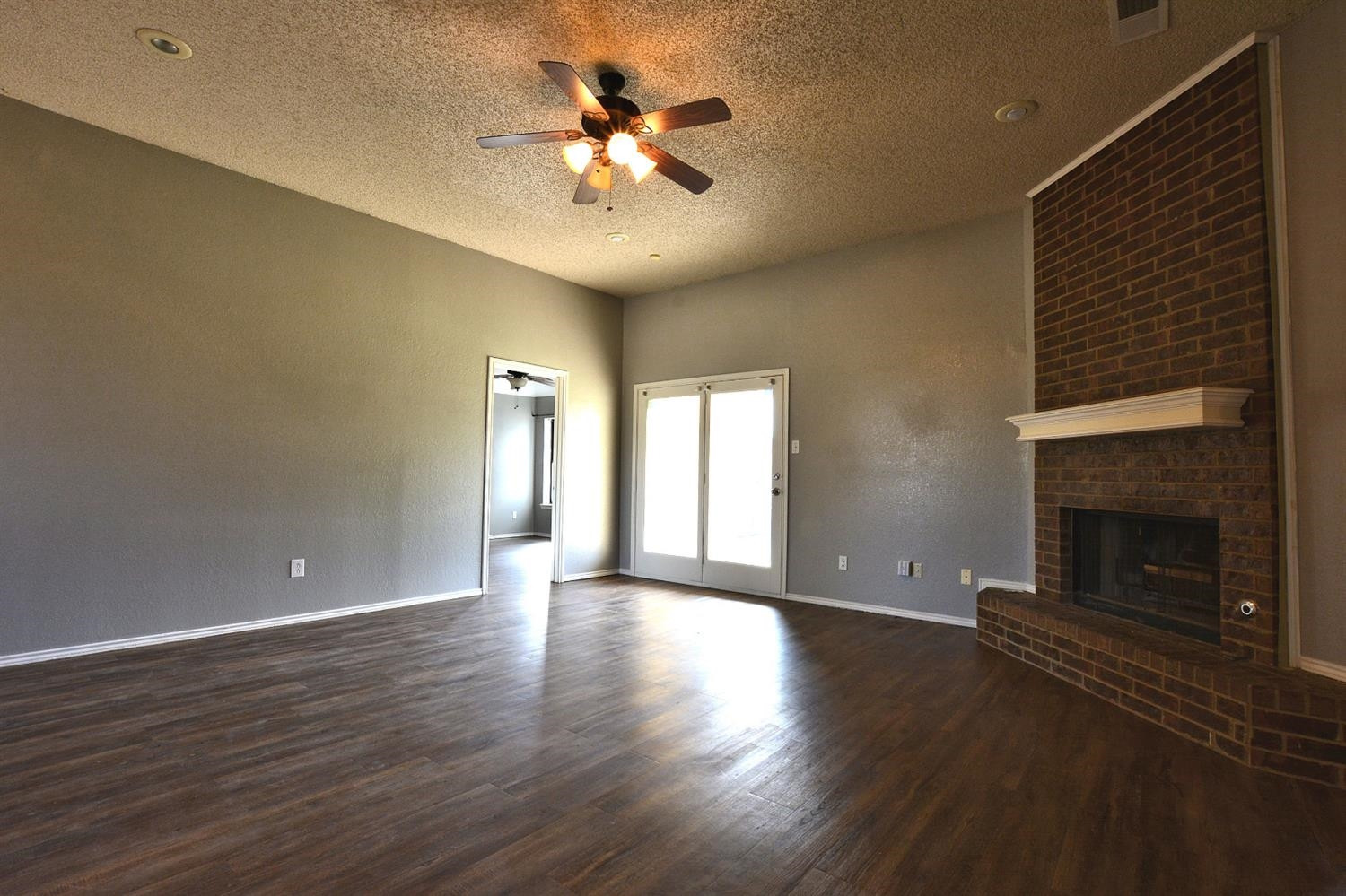 5917 71st Street Lubbock, TX 79424 - Photo 4 of 18 a view of an empty room with a fireplace and a window
