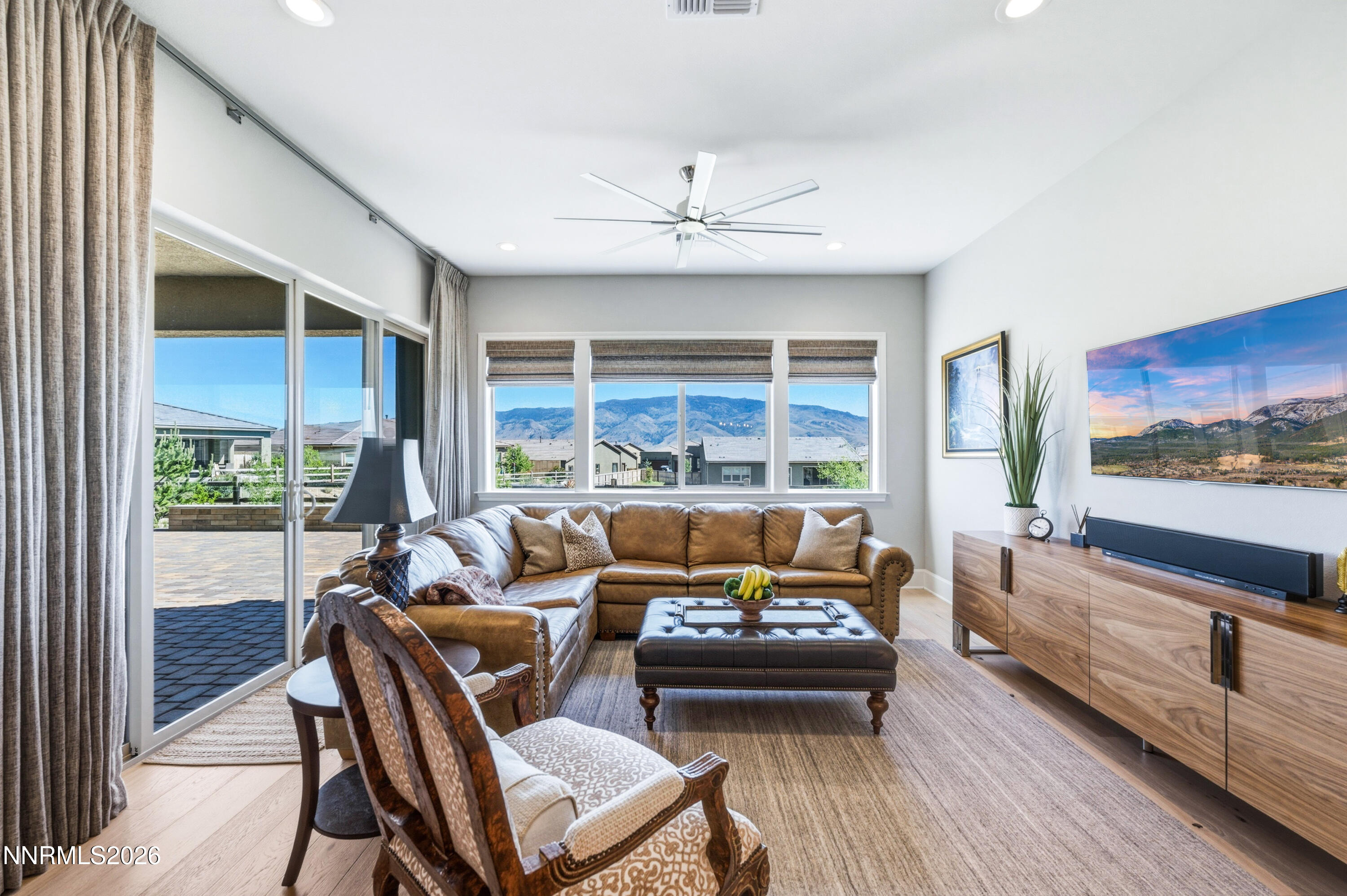 9028 Iron Sky Court Reno, NV 89523 - Photo 21 of 36 a living room with furniture and a flat screen tv