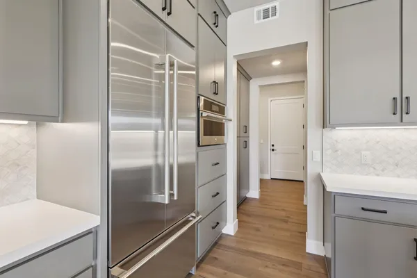 a kitchen with stainless steel appliances granite countertop a refrigerator and a sink