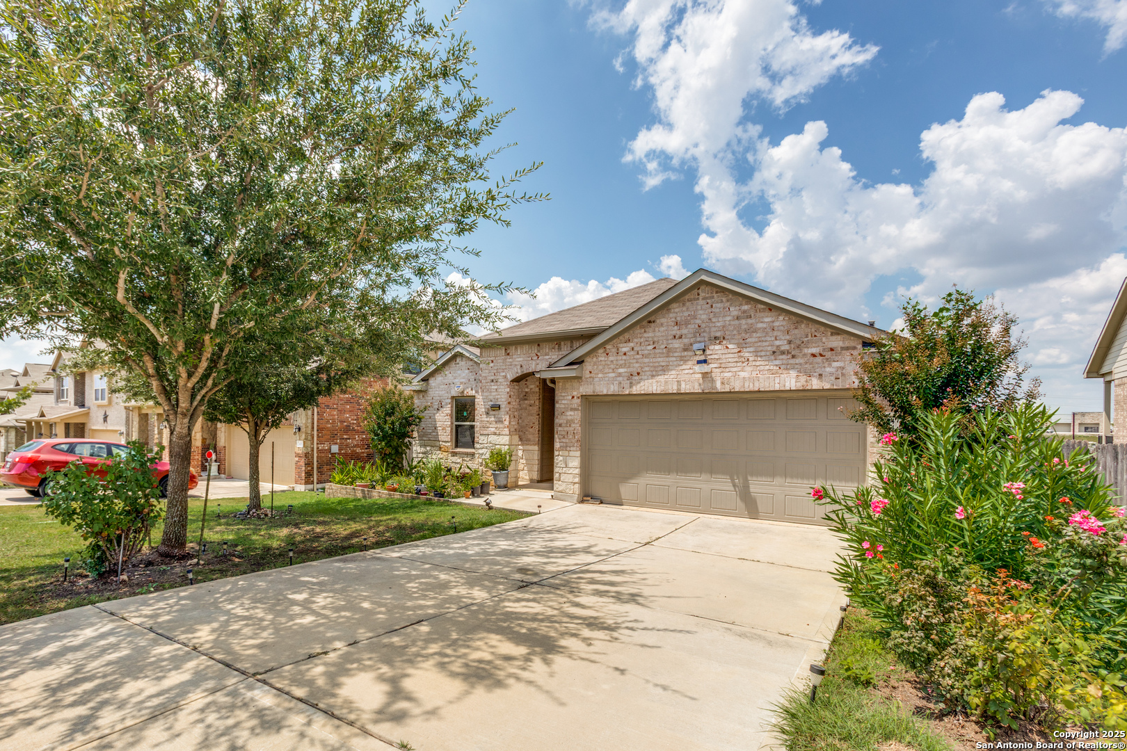 445 Red Morganite Trail Buda, TX 78610 - Photo 2 of 25 a view of a house with a yard and potted plants
