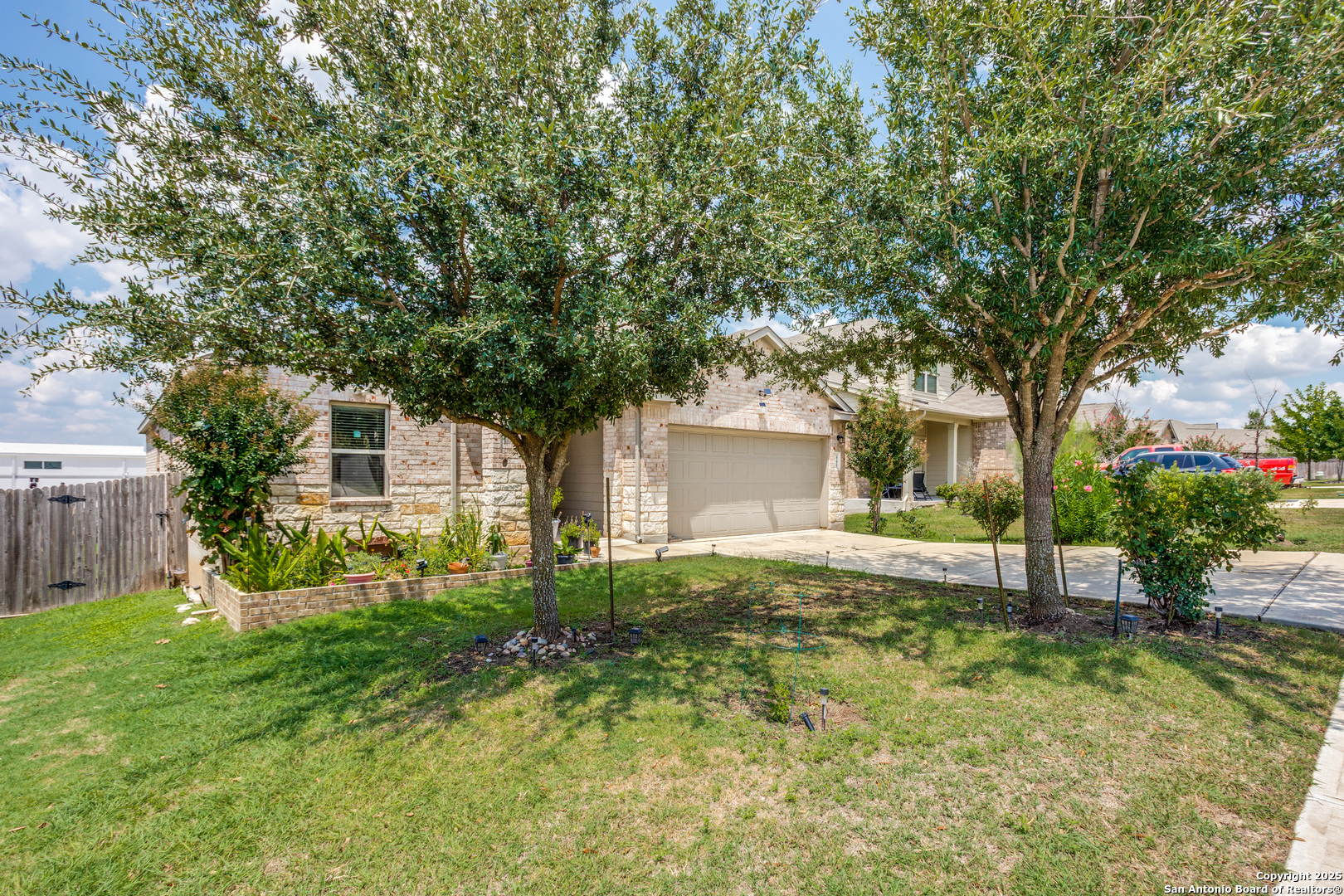 445 Red Morganite Trail Buda, TX 78610 - Photo 25 of 25 a view of a house with backyard and a tree
