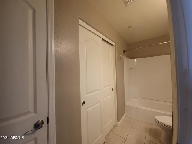 a bathroom with a shower and a glass door