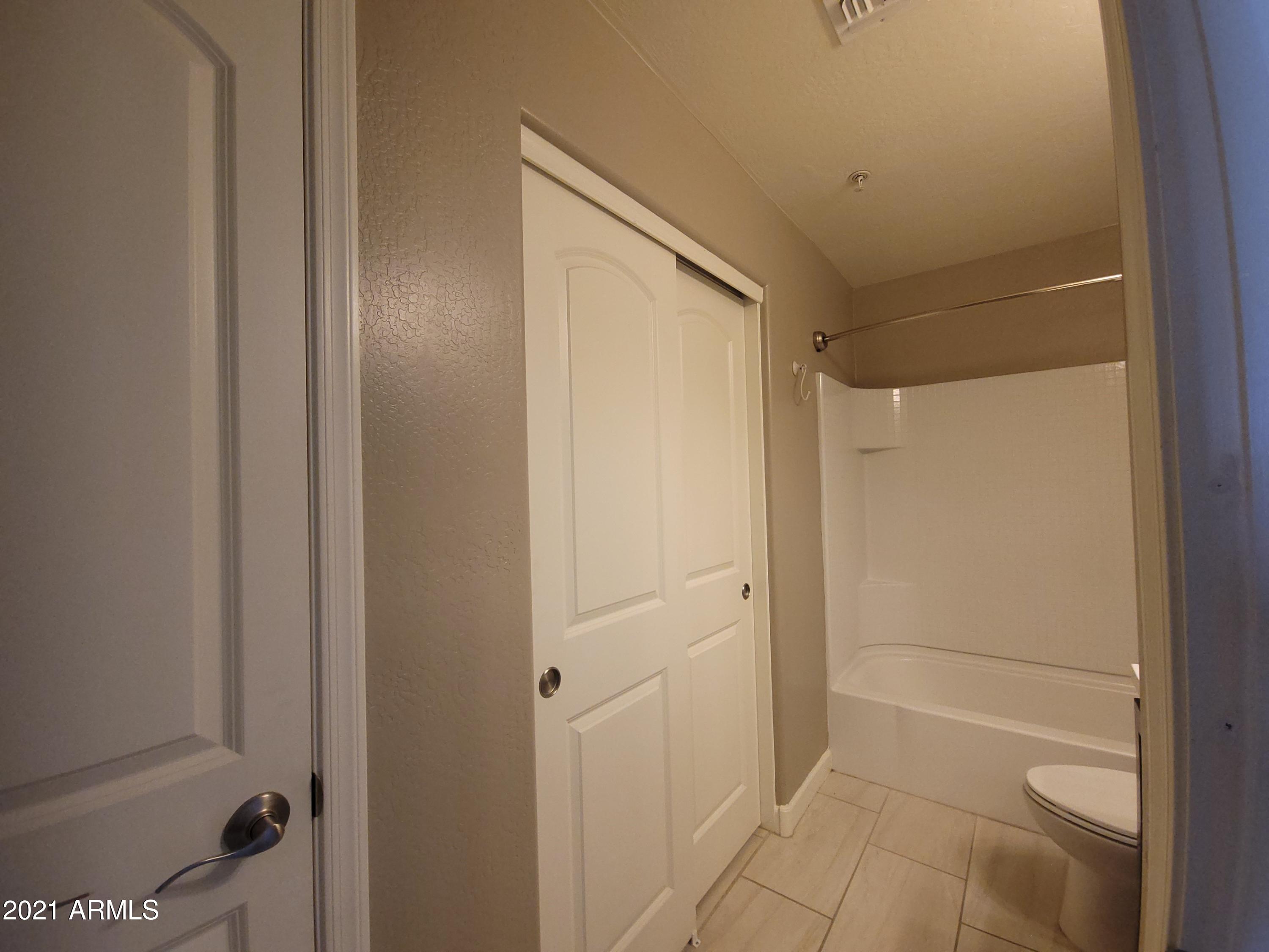 240 West Juniper Avenue, Unit 1111 Gilbert, AZ 85233 - Photo 13 of 22 a bathroom with a shower and a glass door