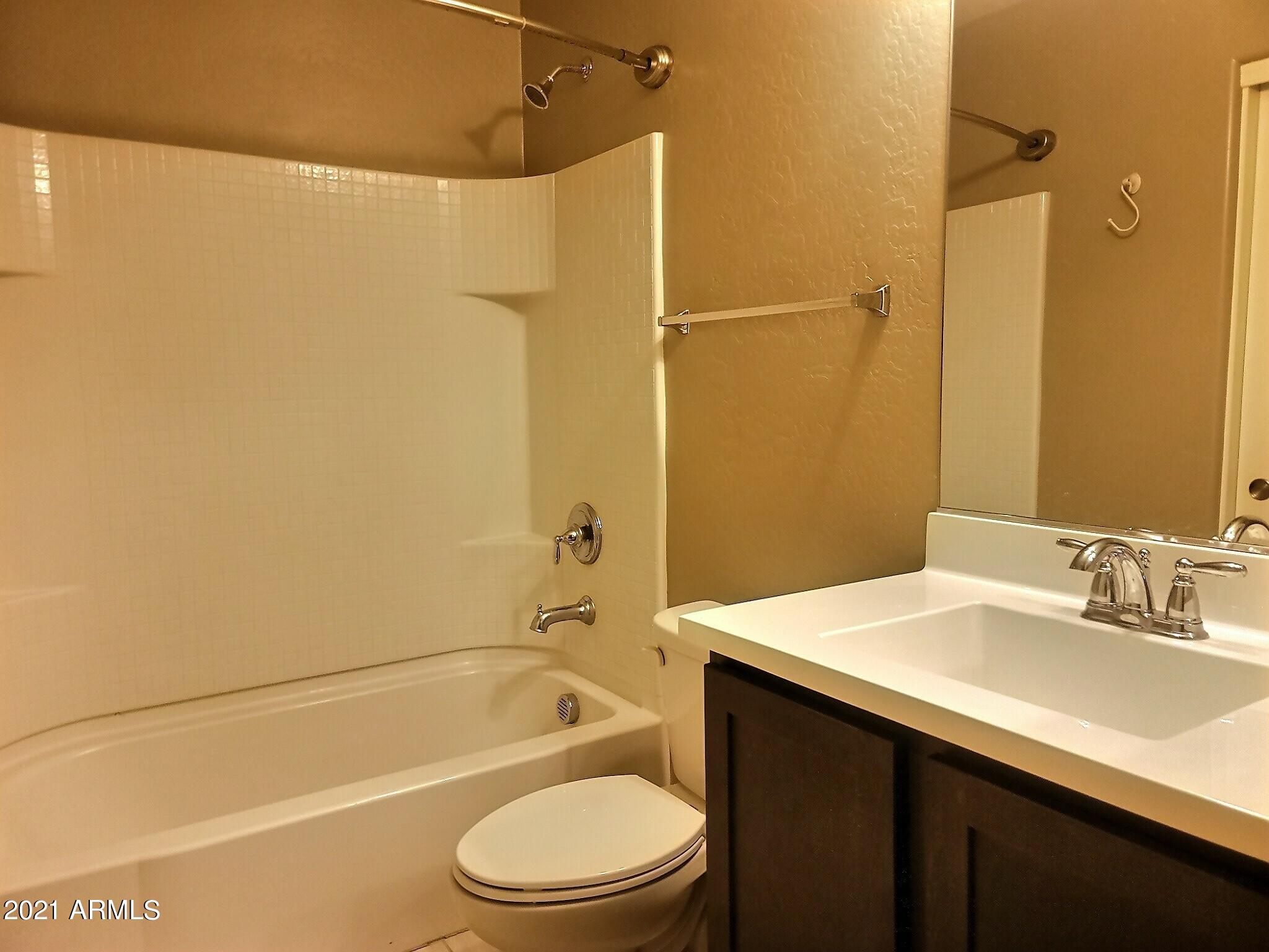 240 West Juniper Avenue, Unit 1111 Gilbert, AZ 85233 - Photo 14 of 22 a bathroom with a sink a toilet and shower