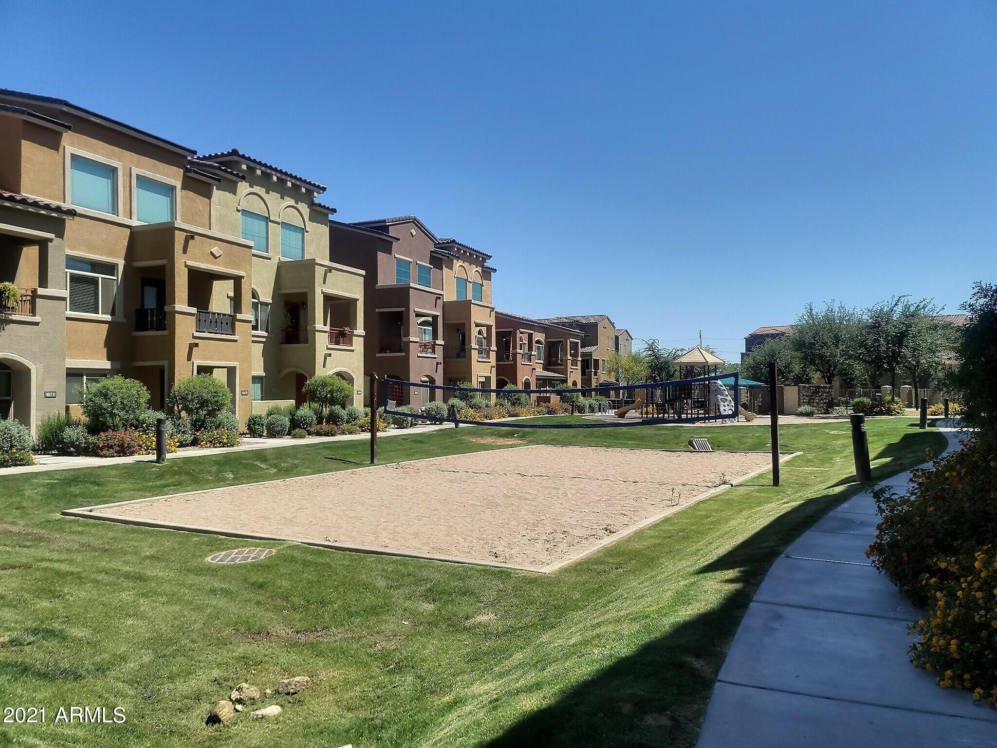 240 West Juniper Avenue, Unit 1111 Gilbert, AZ 85233 - Photo 20 of 22 a view of a swimming pool and a yard