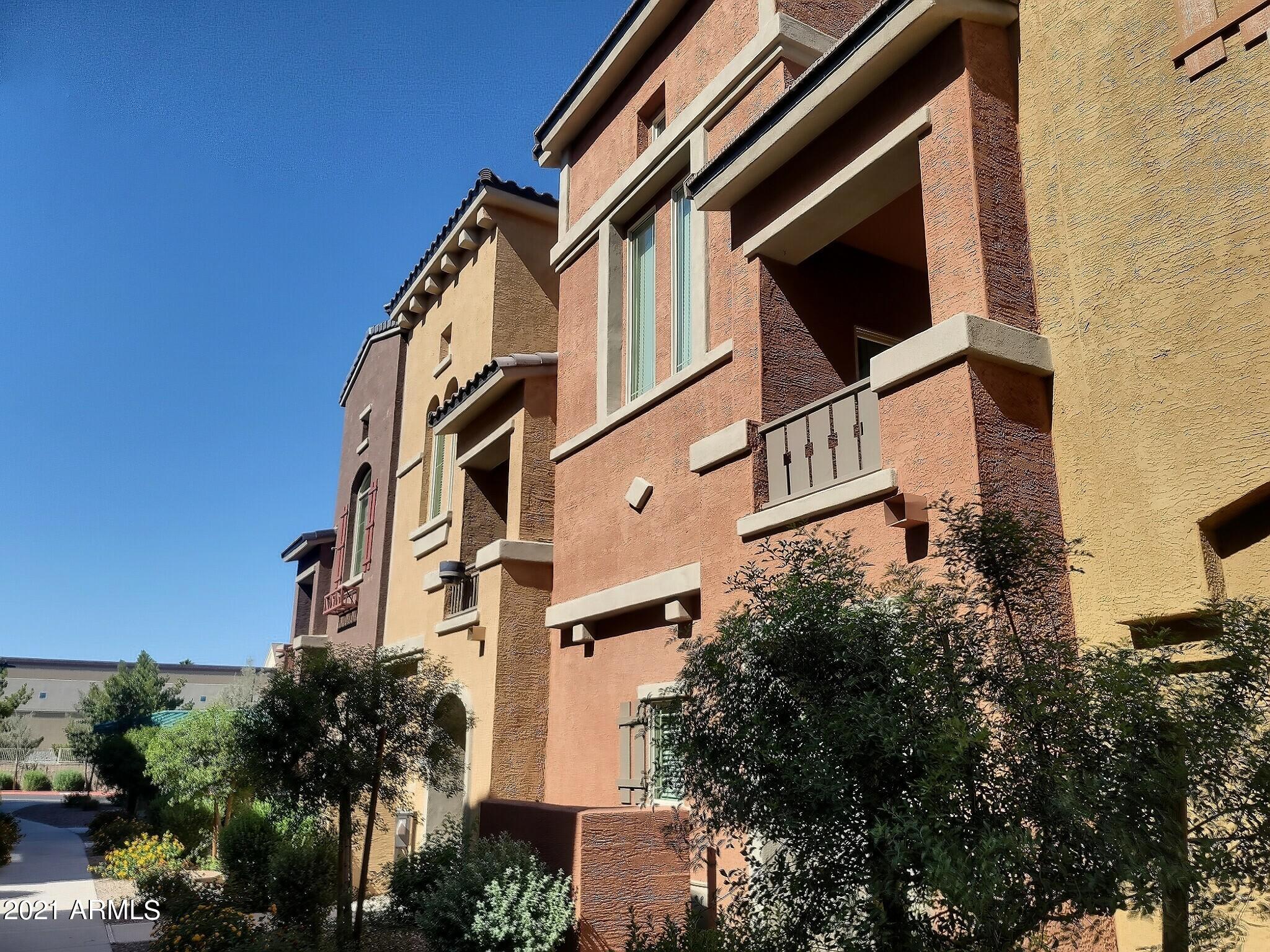 240 West Juniper Avenue, Unit 1111 Gilbert, AZ 85233 - Photo 21 of 22 a front view of a building with a yard
