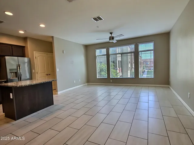 a view of an empty room with window and cabinet