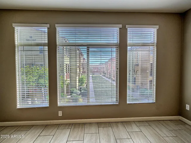 a view of wooden floor and a window in an empty room