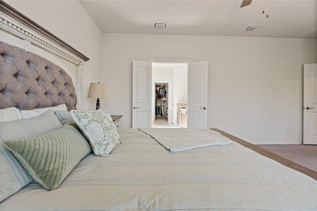 9517 Sunset Lane Oak Point, TX 75068 - Photo 21 of 40 9517 Sunset Lane, Oak Point, TX 75068 - primary bedroom - Bedroom featuring light carpet and ceiling fan