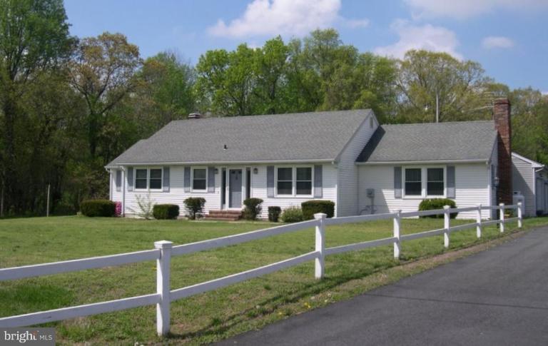 6694 Harmony Road Preston, MD 21655 - Photo 1 of 5 a front view of a house with a yard
