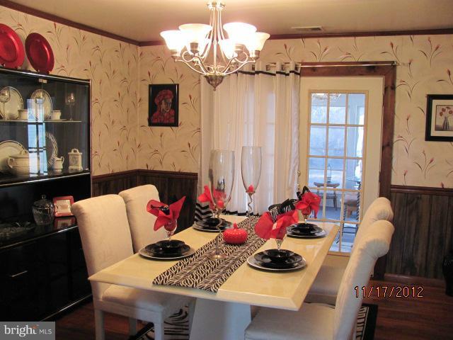 6694 Harmony Road Preston, MD 21655 - Photo 2 of 5 a living room with furniture and a chandelier