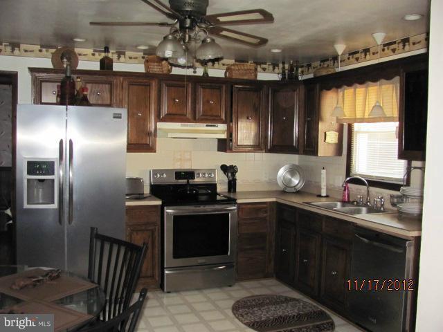 6694 Harmony Road Preston, MD 21655 - Photo 4 of 5 a kitchen with a sink stainless steel appliances and cabinets