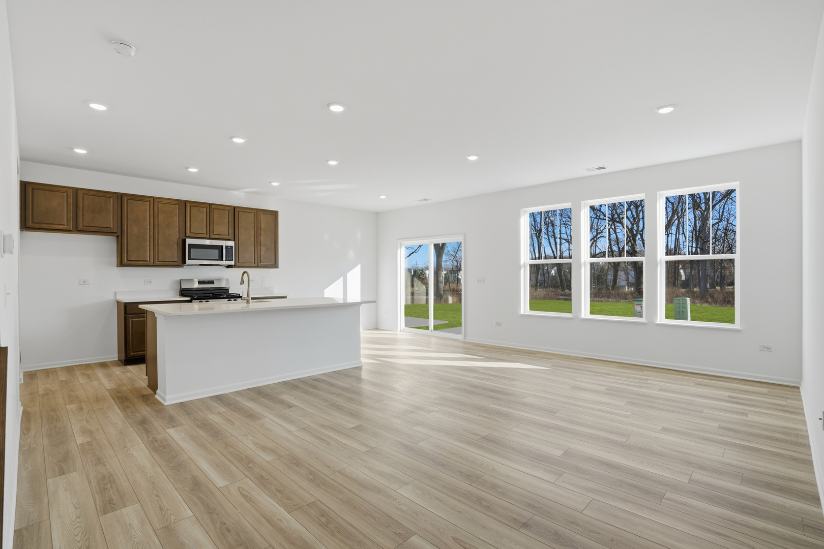 269 Red Oak Circle Volo, IL 60020 - Photo 5 of 17 a view of kitchen with stainless steel appliances granite countertop a stove top oven a sink with wooden floors and cabinets