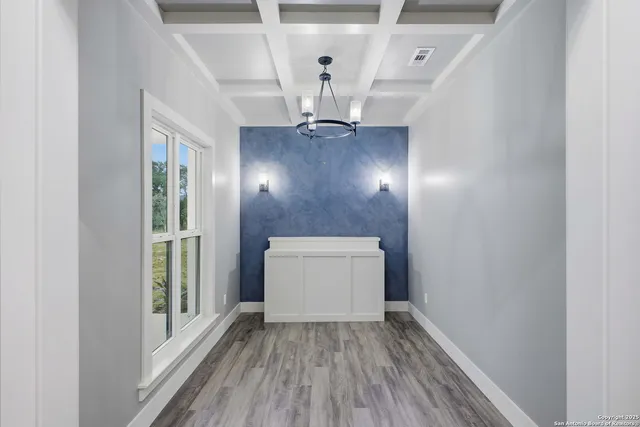 a view of an entryway with wooden floor
