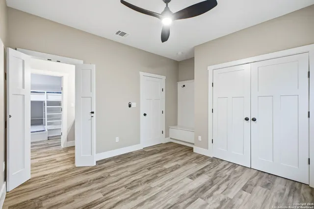 a view of an empty room with wooden floor