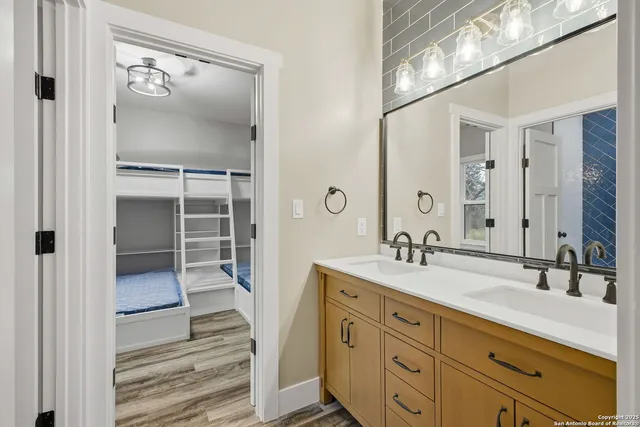 a bathroom with a double vanity sink and a mirror