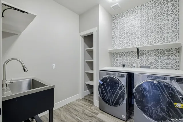 a utility room with a sink a washer and dryer