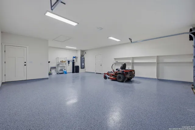 a view of empty room with furniture and a chandelier